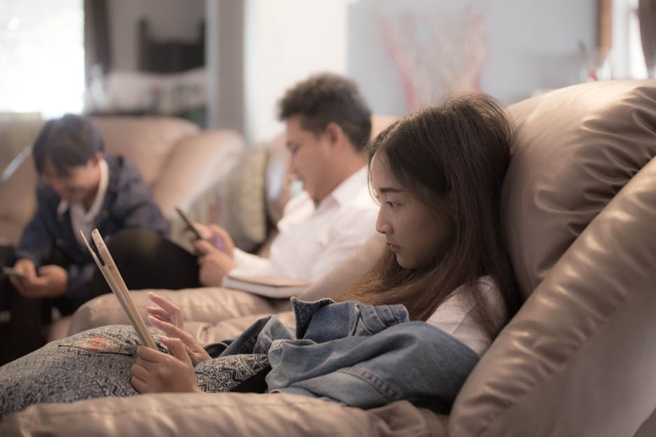 Family watching DEIPTV US on multiple devices including tablet, smartphone and television simultaneously